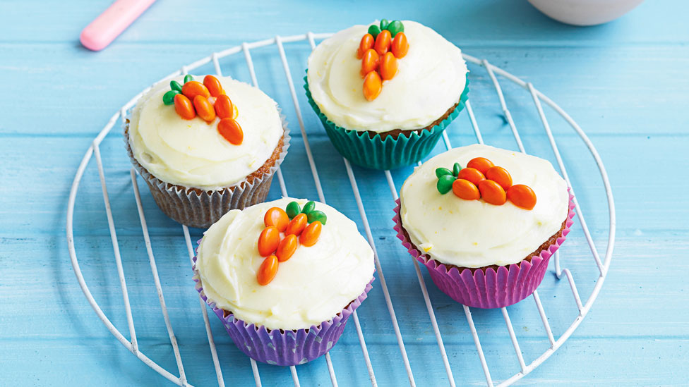 Four Easter bunny cupcakes decorated with carrots