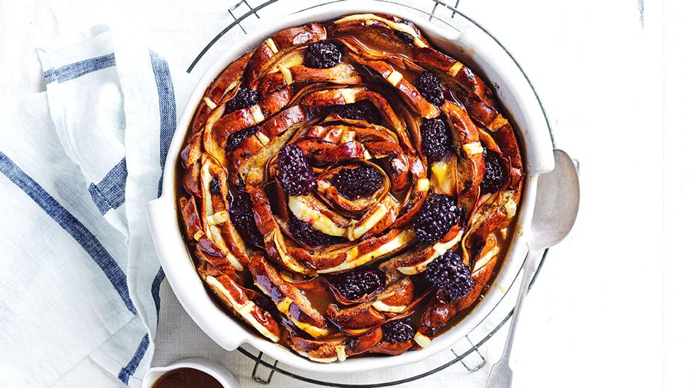 Hot cross bun flower pudding with frozen blackberries