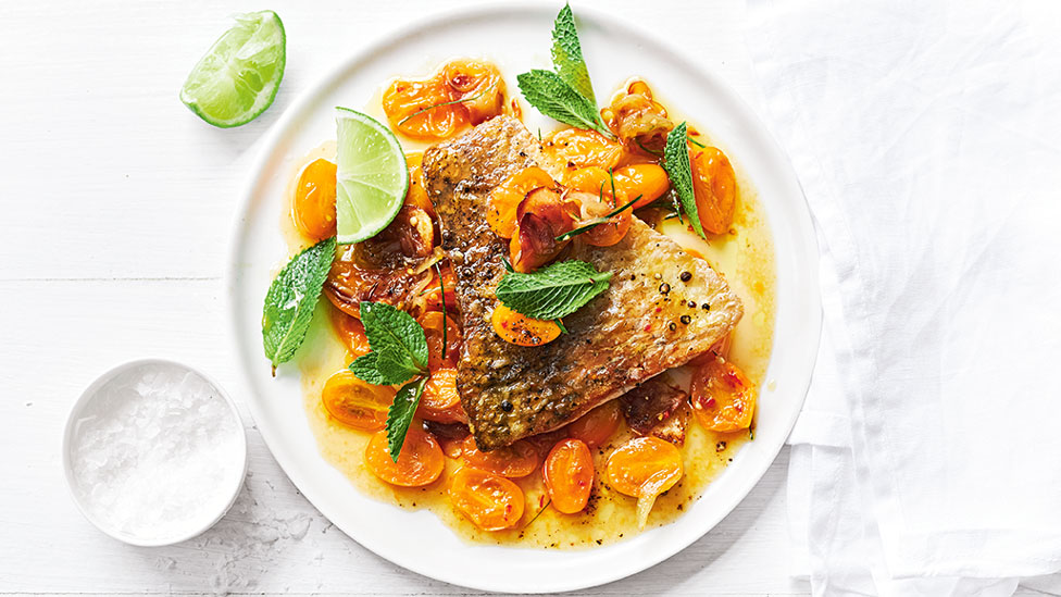 Portions of crispy-skin barramundi with golden tomato, lime and ginger sauce
