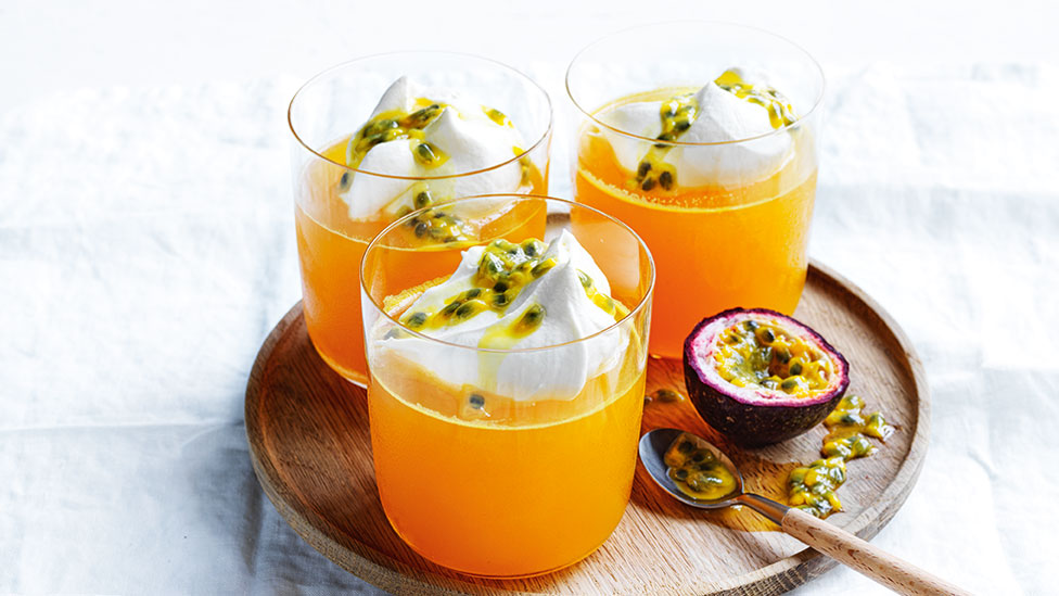Three passionfruit and prosecco jelly cups and a half passionfruit 