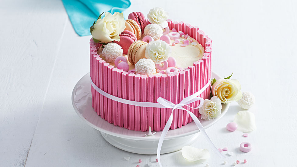 Pretty-in-pink cake with Macarons, lollies and chocolates