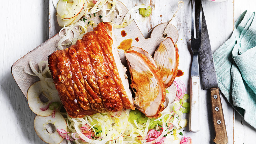 Thickly sliced roast pork with pickled onion salad