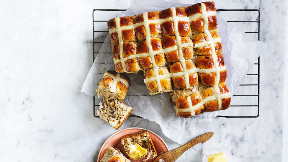 Traditional hot cross buns with butter