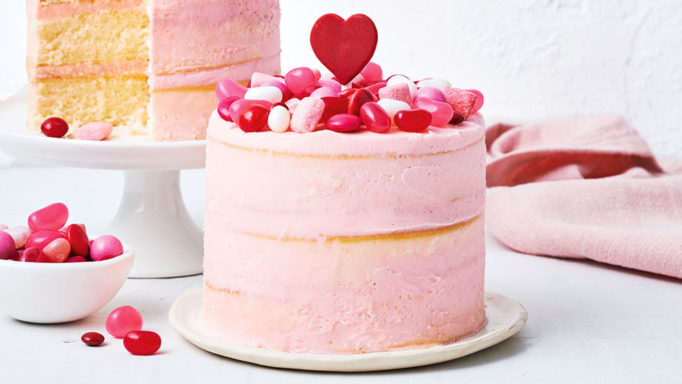 No-bake Valentine’s cake topped with lollies and a pink icing heart