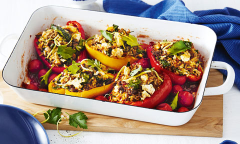 Stuffed side-up capsicums in a roasting pan