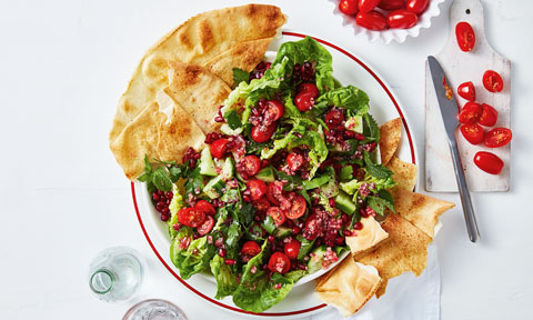A loaded fattoush salad served on crispy pita bread