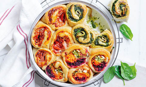 Pull apart sandwiches in a baking dish decorated with some basil