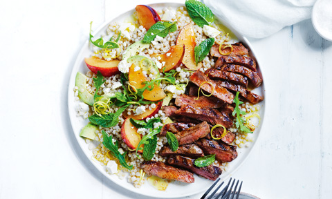 Thickly cut spiced beef steaks with plum and couscous salad