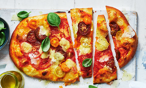 Tomato and bocconcini pizza cut into wedges