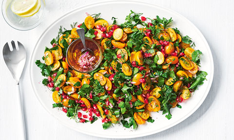 A golden tomato and pomegranate salad with maple syrup dressing