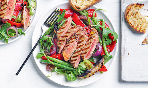 Thickly sliced grilled beef steak with green beans salad