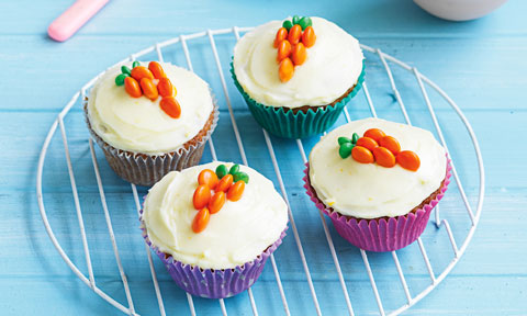 Four Easter bunny cupcakes decorated with carrots