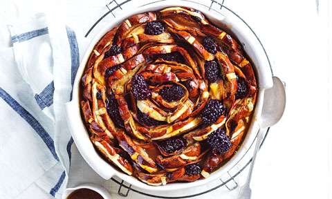 Hot cross bun flower pudding with frozen blackberries