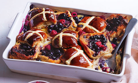 Hot cross bun pudding with raspberries and blueberries