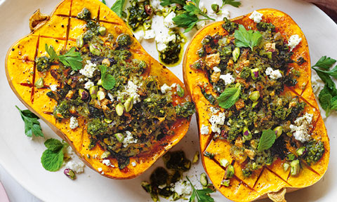 A rice-stuffed butternut pumpkin cut in half