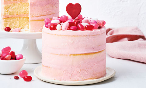 No-bake Valentine’s cake topped with lollies and a pink icing heart