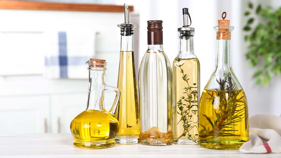 collection of oils in glass bottles with herbs