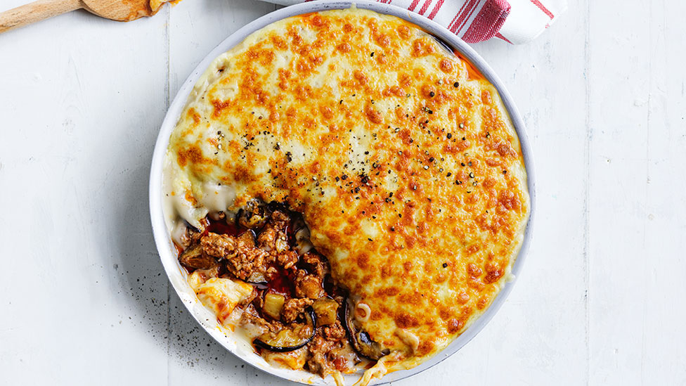 Cheesy lamb bake served in a baking dish with a spoonful removed