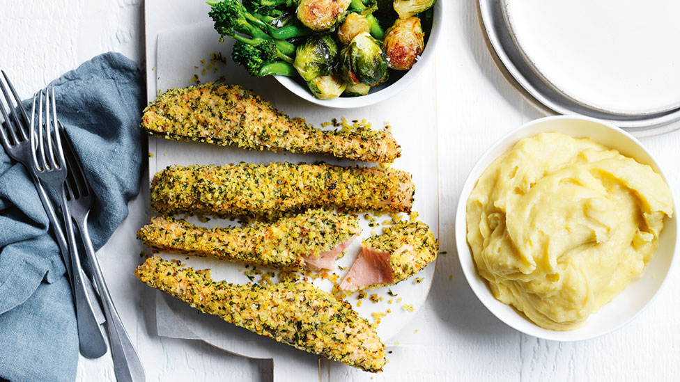 Four pieces of lemon and herb crusted salmon served with veggies on the side