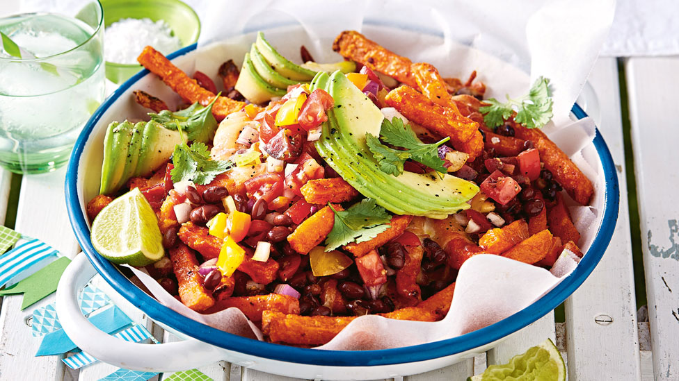 Sweet potato fries topped with beans, corn, avocado and coriander