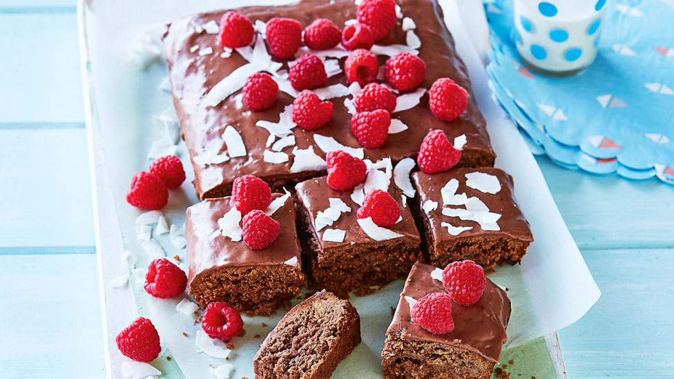 Milo and weet-bix slice with flaked coconut and raspberries on top