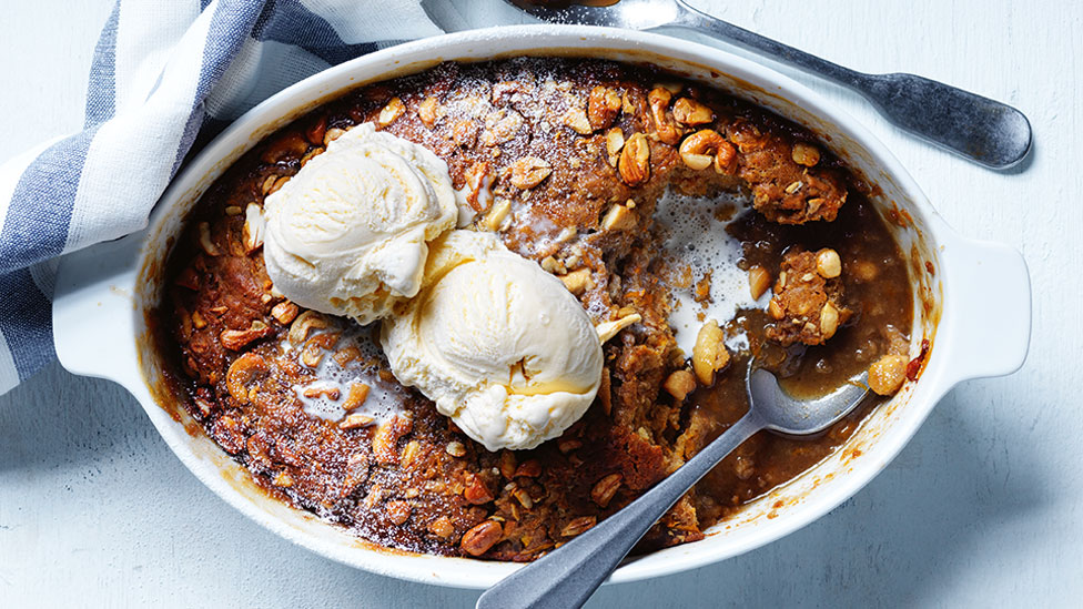 Pumpkin and caramel self-saucing pudding served in a baking dish with two scoops of ice-cream on top