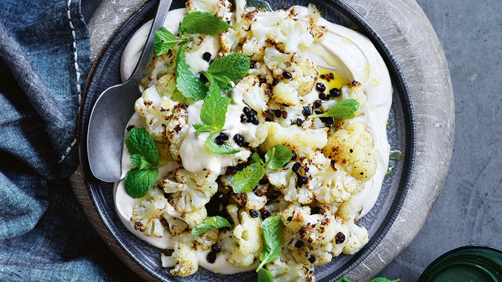 Cauliflower salad served in a bowl with mint on top