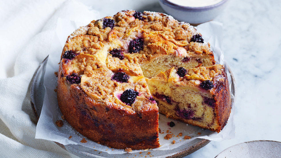 Whole blackberry and apple streusel cake served on a plate 