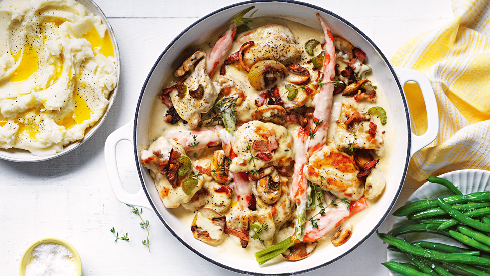 Creamy chicken, bacon and mushroom served in a oven dish with green beans and mashed potatoes on the side