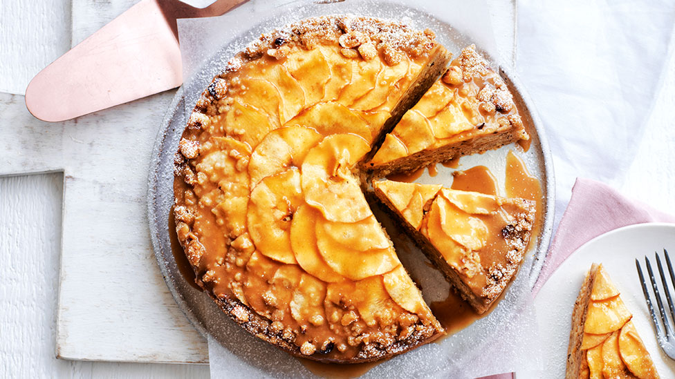 Apple cake served on plate and cut into three slices 