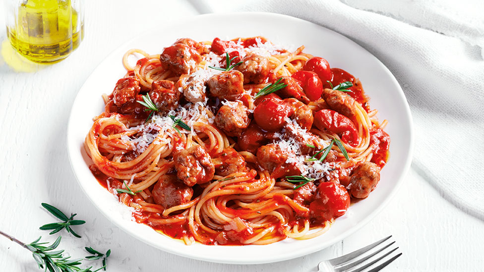 Sausages served in spaghetti sauce with rosemary and parmesan cheese 