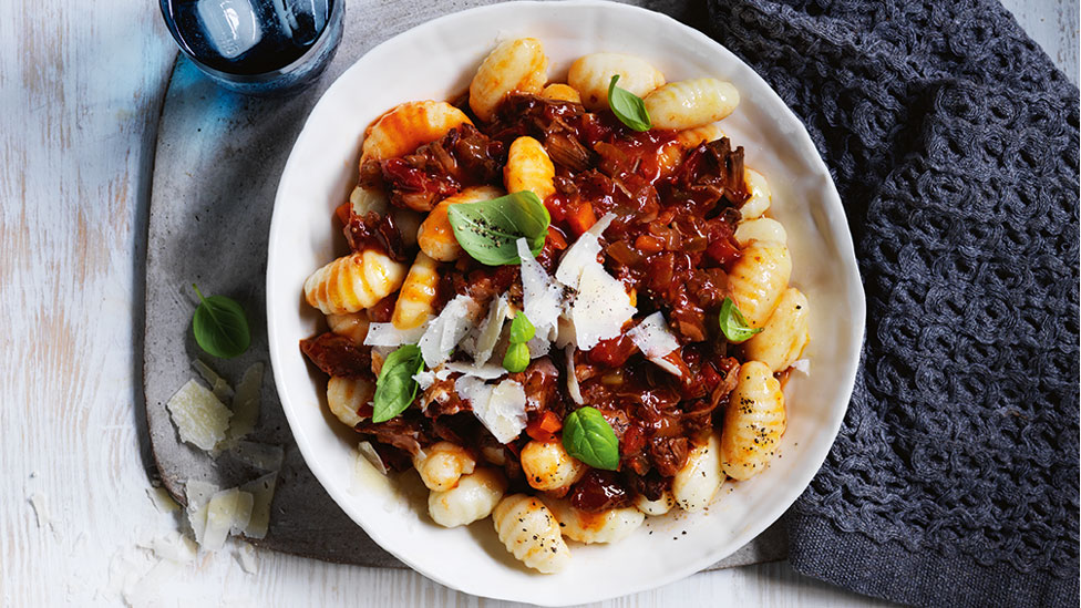 Potato gnocchi topped with beef ragu, basil and parmesan flakes