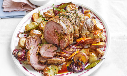 Chilli and Parmesan Roast Lamb sliced on roast vegetables. Topped with sprigs of thyme.