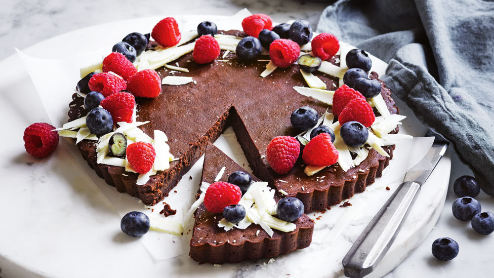 Chocolate and Raspberry Truffle Tart on marble plate