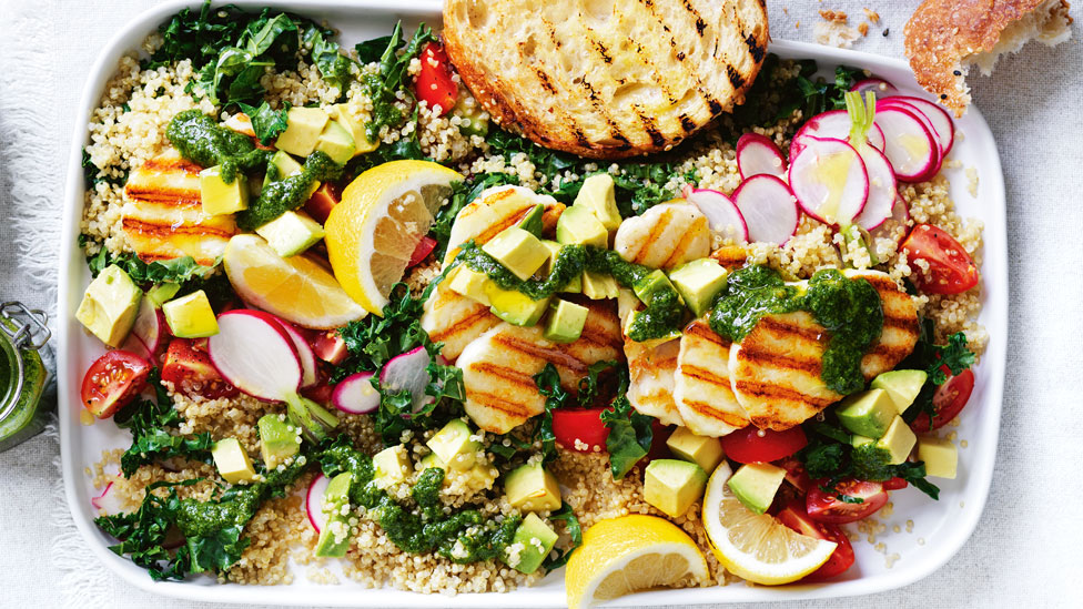 Haloumi and Quinoa Salad garnished with lemon, radish and pesto. Served with chargrilled bread.