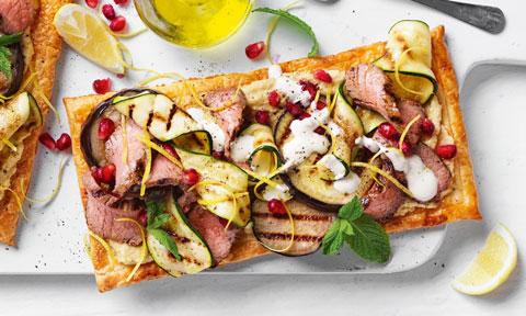 Lamb and Eggplant Pastry Pizzas on board with lemons