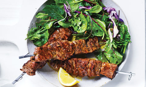 Lemon and Herb Lamb Skewers, served with a side salad and a lemon wedge