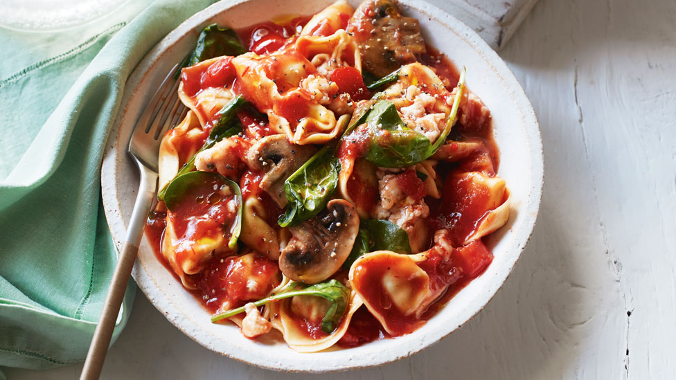 Mushroom, Sausage and Spinach Tortellini in a rich tomato sauce, served in a dinner bowl