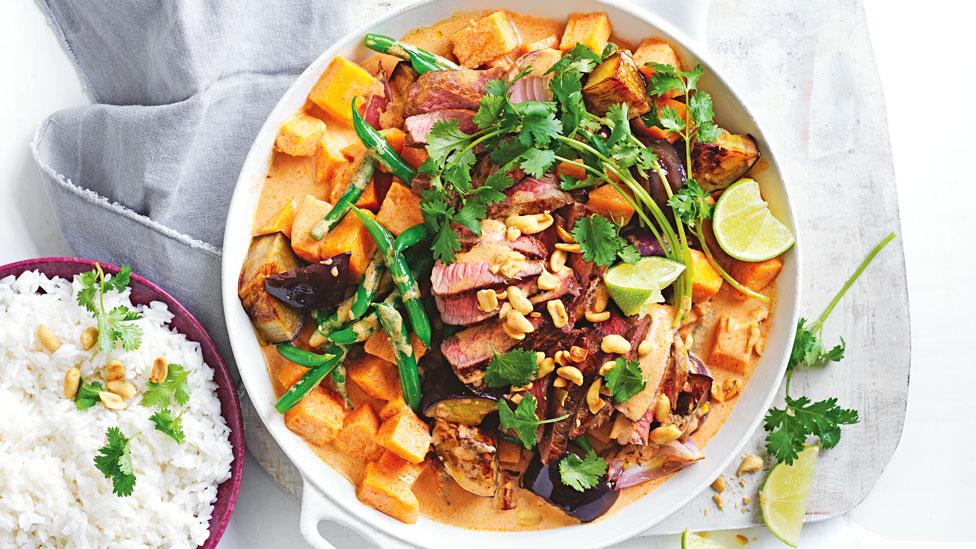 One-pot Massaman Beef Curry garnished with peanutes and lime, served with jasmine rice