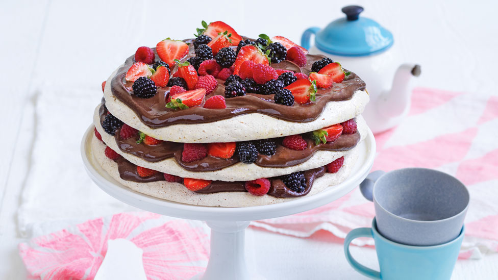 Choc-hazelnut and Berry Meringue Torte on serving plate