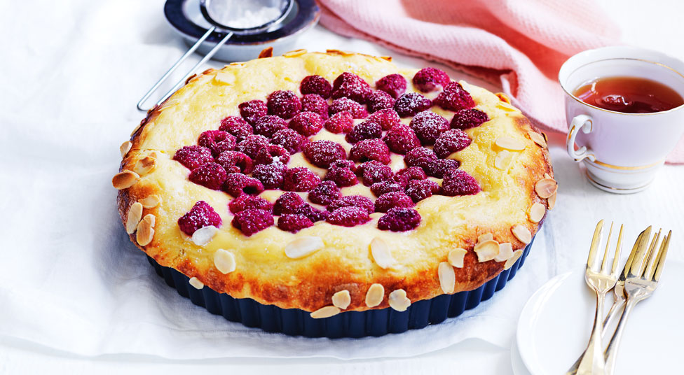 Raspberry custard brioche tart in pan on white tea towelRaspberry custard brioche tart in pan on white tea towel