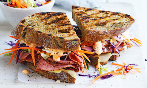 Reuben Sandwich, cut in two, on a plate