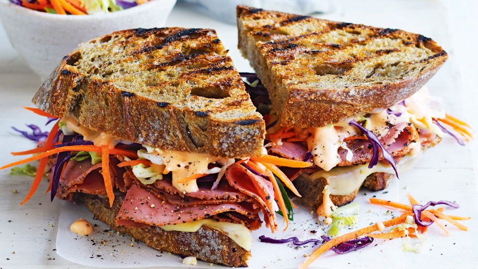 Reuben Sandwich, cut in two, on a plate