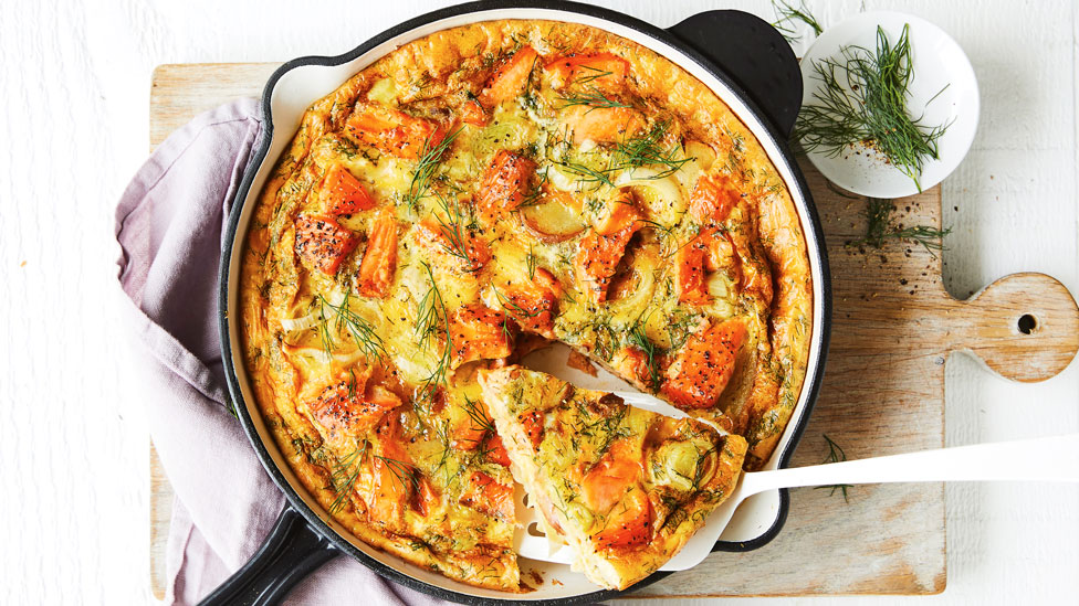 Salmon and Leek Frittata in pan, with a side of dill sprigs