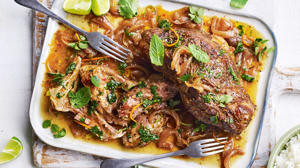 Slow Roasted Cuban Mojo Pork on serving plate, dressed with Mint leaves