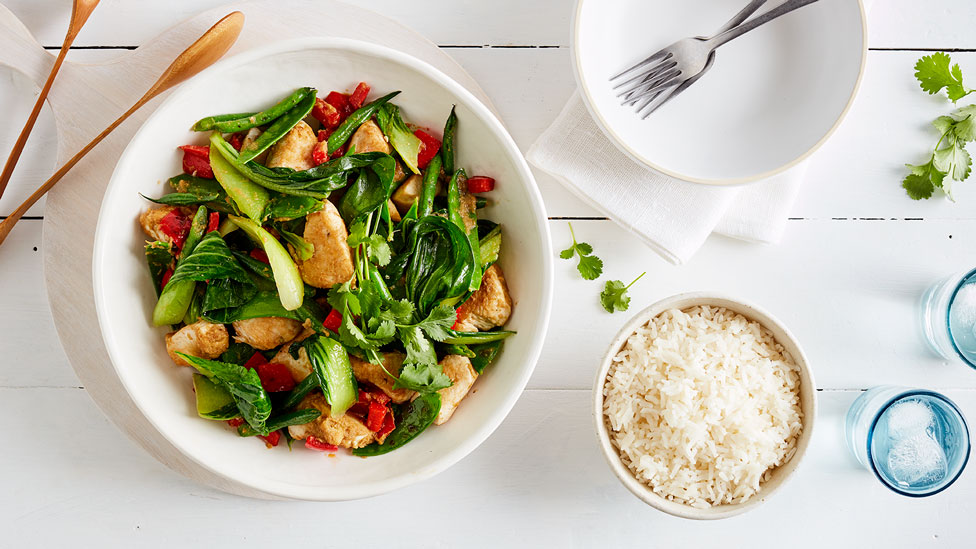 Thai-style Green Chicken Stir-Fry in a bowl with a side of rice