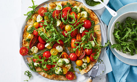 Wholemeal Pizzas with Tomato and Pesto, cut into four slices, with a side bowl of rocket