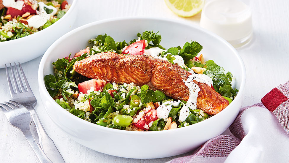 Quinoa salad topped with baked salmon