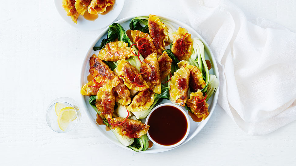 Pork gyoza with Asian-style greens and noodle salad dressing