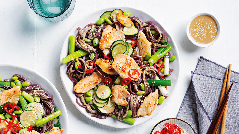 Tahini sesame chicken with black noodles and zucchini slices